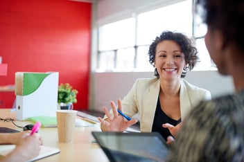 Unposed group of creative business people in an open concept office brainstorming their next project.-3