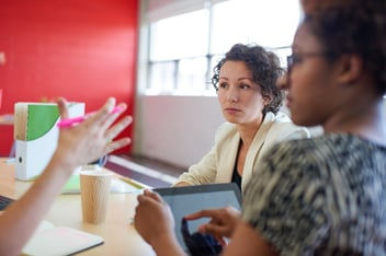 Unposed group of creative business people in an open concept office brainstorming their next project.